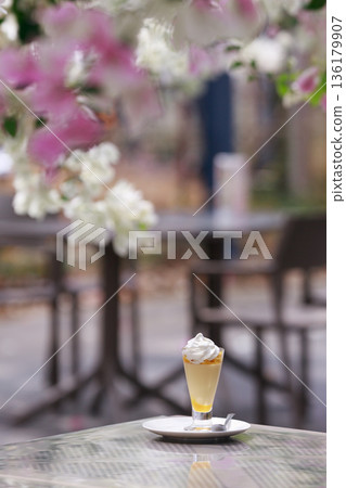 Glass dessert and whipped cream on a cafe table 136179907