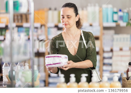 Middle-aged woman choosing feminine pads in chemistry 136179956