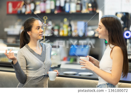 Two women talking over cup of coffee in cafe Two women talking over cup of coffee in cafe 136180072