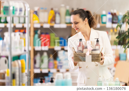Adult woman buyer chooses cosmetics gift set 136180076
