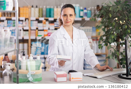 Woman pharmacist offers medication drug remedy Woman pharmacist offers medication drug remedy 136180412