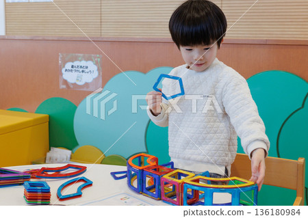 Boy playing with educational toys Boy playing with educational toys 136180984
