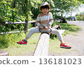 Boy playing with seesaw 136181023