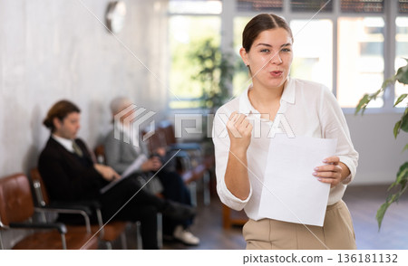 Cheerful young business woman making woohoo gesture Cheerful young business woman making woohoo gesture 136181132