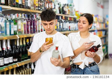 Married couple scans QR code from label on alcoholic drink 136181134
