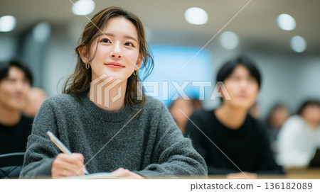 A young Japanese female employee shows a positive attitude at the seminar 136182089