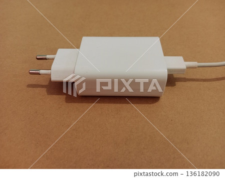 smartphone charger on brown cardboard 136182090