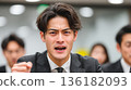 A Japanese businessman explodes with frustration and yells violently 136182093