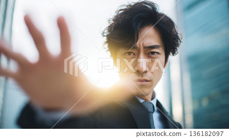 A Japanese man reaching out towards the light, trying to grab something 136182097