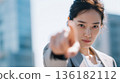 A Japanese businesswoman pointing without hesitation towards her goal 136182112