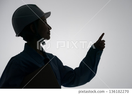 Silhouette of a woman in work clothes Silhouette of a woman in work clothes 136182270