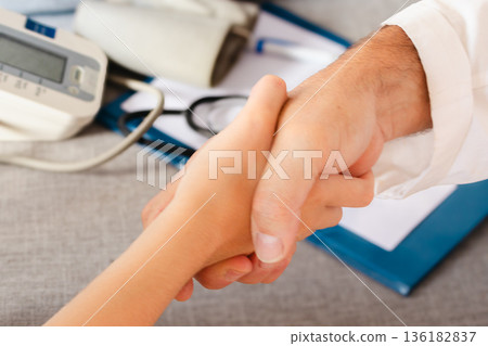 Doctor and patient hands shaking, conveying trust and understanding in a medical consultation .World Day for the Prevention of Cardiovascular Diseases Doctor and patient hands shaking, conveying trust and understanding in a medical consultation .World Day for the Prevention of Cardiovascular Diseases 136182837