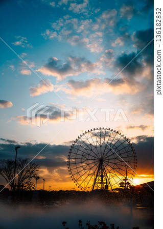 Ferris wheel at Kasai Rinkai Park with dramatic sky background at sunset Ferris wheel at Kasai Rinkai Park with dramatic sky background at sunset 136182852