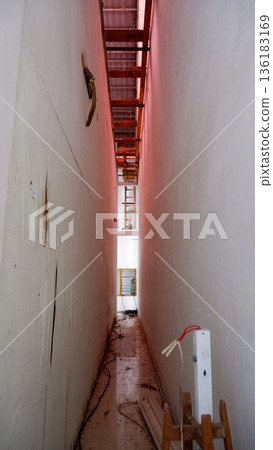 Narrow Maintenance Alleyway Inside Building Under Construction Narrow Maintenance Alleyway Inside Building Under Construction 136183169