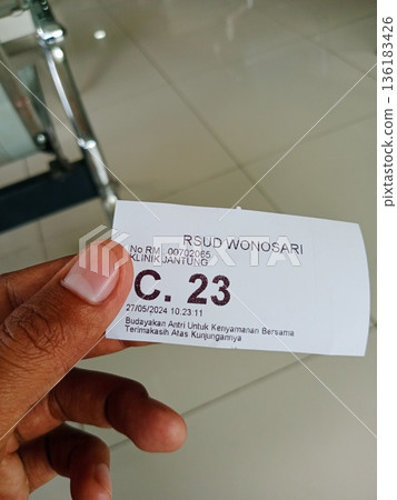 a patient shows proof of queue number at a health center in Yogyakarta, Indonesia on 05-27-2024 a patient shows proof of queue number at a health center in Yogyakarta, Indonesia on 05-27-2024 136183426