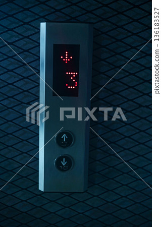 Elevator Up Down Button Panel, A clean photo of elevator up down button panel, buttons with clear labels in sleek metal frame under, for modern building or urban convenience documentary. Elevator Up Down Button Panel, A clean photo of elevator up down button panel, buttons with clear labels in sleek metal frame under, for modern building or urban convenience documentary. 136183527