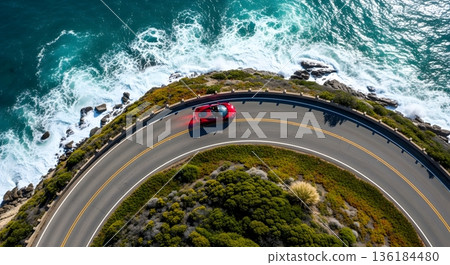Aerial View Of Red Car On Coastal Road Along Crashing Waves And Rocky Shoreline 136184480