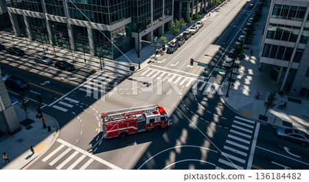 Aerial View of Red Fire Truck at City Intersection with Buildings and Crosswalks under Sunlight 136184482