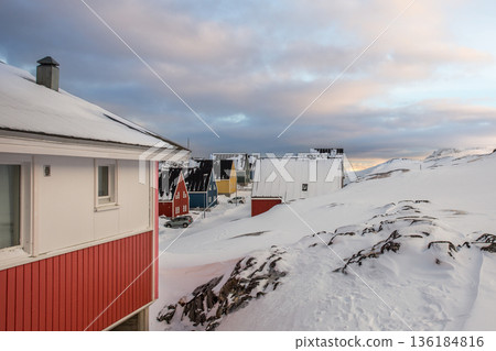 Greenlandic residential area with colorful wooden houses built on a snow covered slope showing traditional Inuit architecture during winter, Nuuk, Greenland Greenlandic residential area with colorful wooden houses built on a snow covered slope showing traditional Inuit architecture during winter, Nuuk, Greenland 136184816