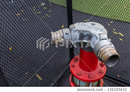 Hydrant with water hoses and fire extinguish equipment. 136185632