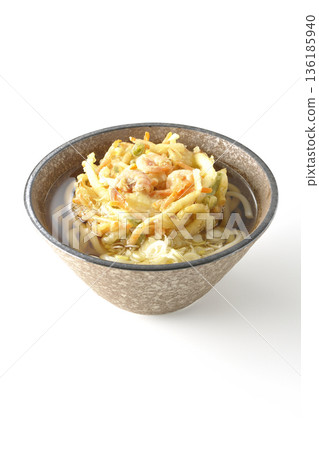 Shrimp and vegetable tempura udon noodles photographed on a white background 136185940