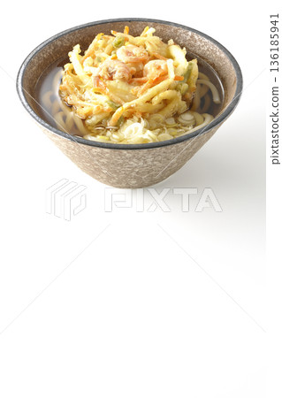 Shrimp and vegetable tempura udon noodles photographed on a white background 136185941