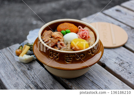 Eating a warm Kamameshi outdoors Eating a warm Kamameshi outdoors 136186210