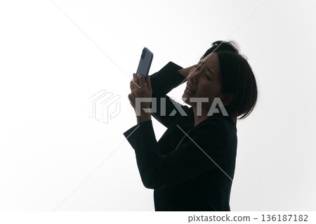 A woman in a suit messing up her head 136187182