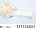 White tube diploma holder and bouquet of white roses 136188804