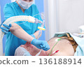 An elderly man is injected with an endotracheal tube. Tracheal intubation. Anesthesia before surgery. Modern medicine. Preparation for operation. 136188914