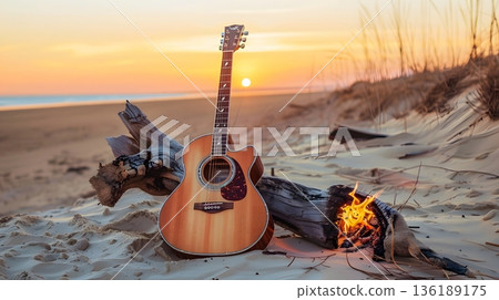 A guitar on the beach at sunset and memories of a summer trip 136189175