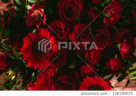 Dense cluster of deep red carnations creates dramatic texture. Moody floral design, gothic romance, dramatic floral arrangement. Dense cluster of deep red carnations creates dramatic texture. Moody floral design, gothic romance, dramatic floral arrangement. 136190070