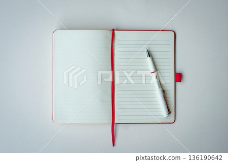 Open lined notebook with red bookmark and pen Open lined notebook with red bookmark and pen 136190642
