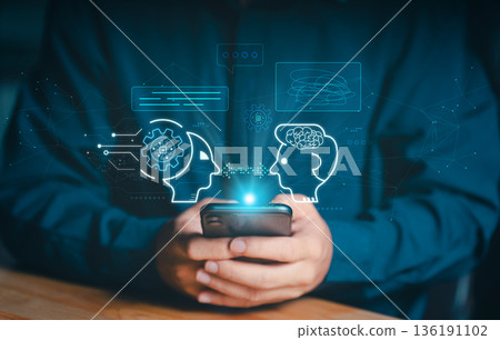 User interacting with AI chatbot on smartphone with digital holographic icons. Concept of human robot communication, virtual assistance, neural networks, and machine learning technology. User interacting with AI chatbot on smartphone with digital holographic icons. Concept of human robot communication, virtual assistance, neural networks, and machine learning technology. 136191102