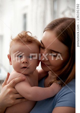 Cherished moments between mother and baby showcasing love, connection, and tenderness in a warm, cozy environment emphasizing family bonding concept 136191392