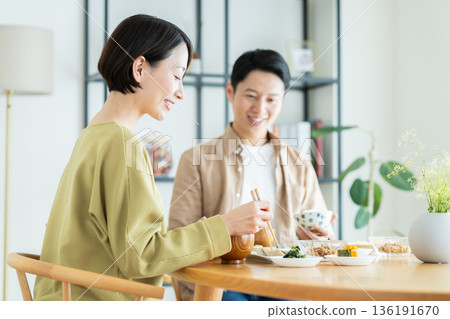 A middle-aged couple having a meal at home A middle-aged couple having a meal at home 136191670