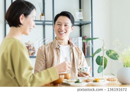 A middle-aged couple having a meal at home A middle-aged couple having a meal at home 136191672