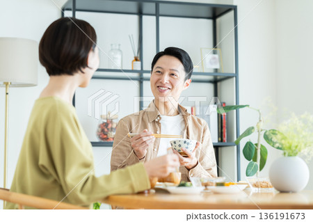 A middle-aged couple having a meal at home A middle-aged couple having a meal at home 136191673