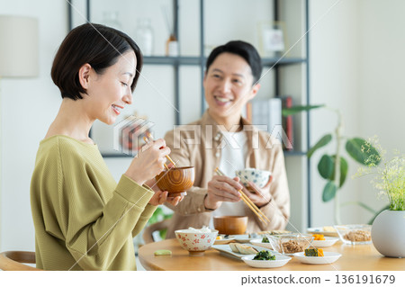 A middle-aged couple having a meal at home A middle-aged couple having a meal at home 136191679
