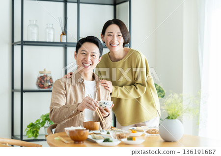 A middle-aged couple having a meal at home A middle-aged couple having a meal at home 136191687