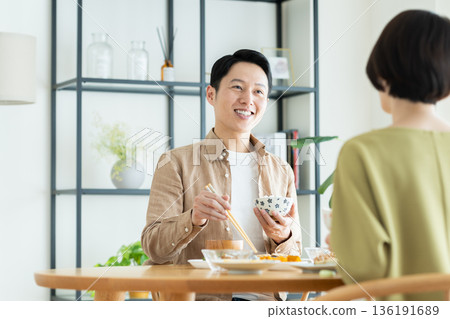 A middle-aged couple having a meal at home A middle-aged couple having a meal at home 136191689