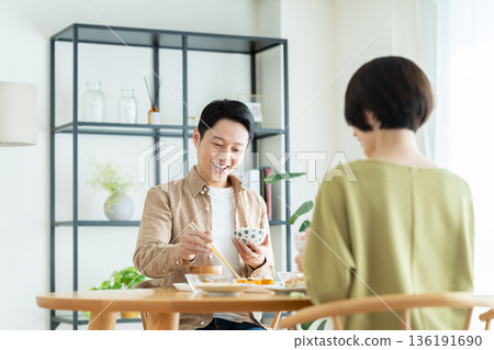 A middle-aged couple having a meal at home 136191690