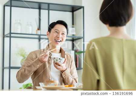 A middle-aged couple having a meal at home A middle-aged couple having a meal at home 136191696