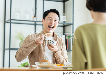 A middle-aged couple having a meal at home A middle-aged couple having a meal at home 136191697