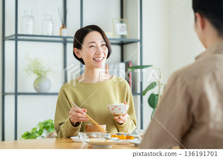 A middle-aged couple having a meal at home 136191701