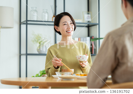 A middle-aged couple having a meal at home 136191702