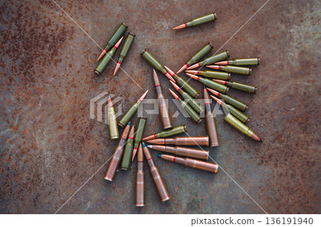 Rifle Ammunition on Rusty Metal Background Rifle Ammunition on Rusty Metal Background 136191940