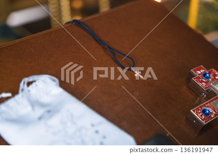 Small Cross Necklace on Wooden Surface Small Cross Necklace on Wooden Surface 136191947