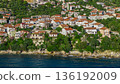 Aerial view of Podgora coastal residential area with traditional houses and Adriatic Sea Croatia 136192009