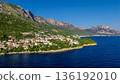 Aerial view of Podgora coastal village on Makarska Riviera Croatia with Biokovo mountains and Adriatic Sea 136192010